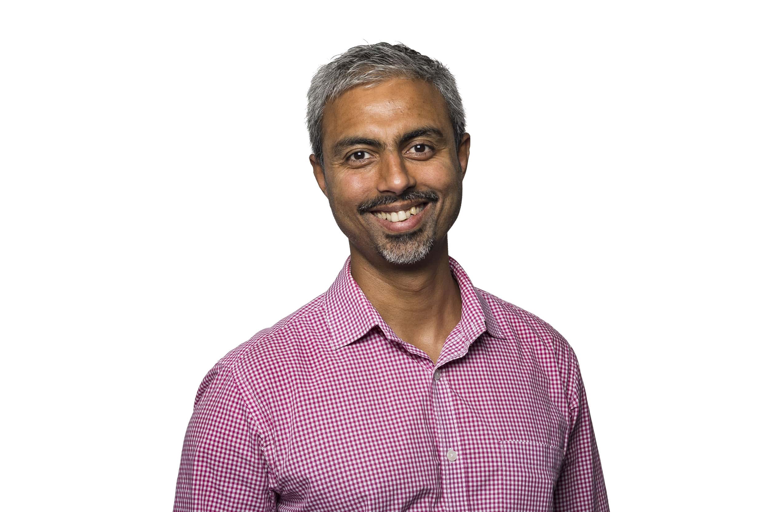 Staff photo of man, upper body studio style with a white background.