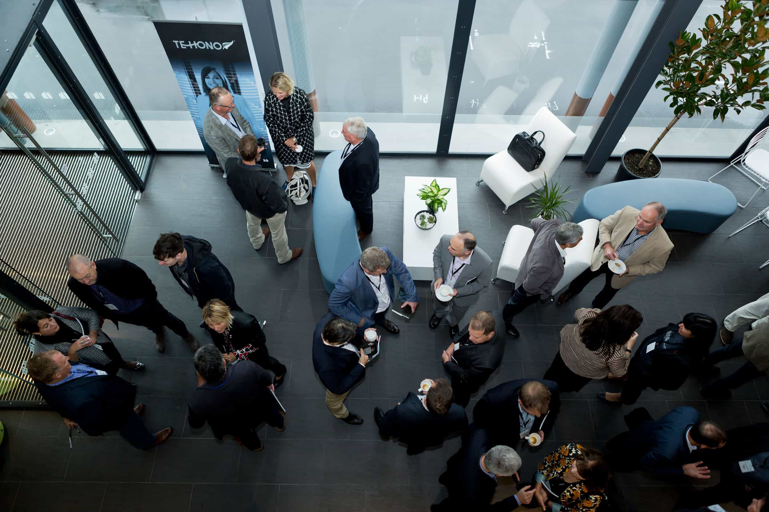 Elevated view of delegates mingling over coffee at The Piano, CHCH.