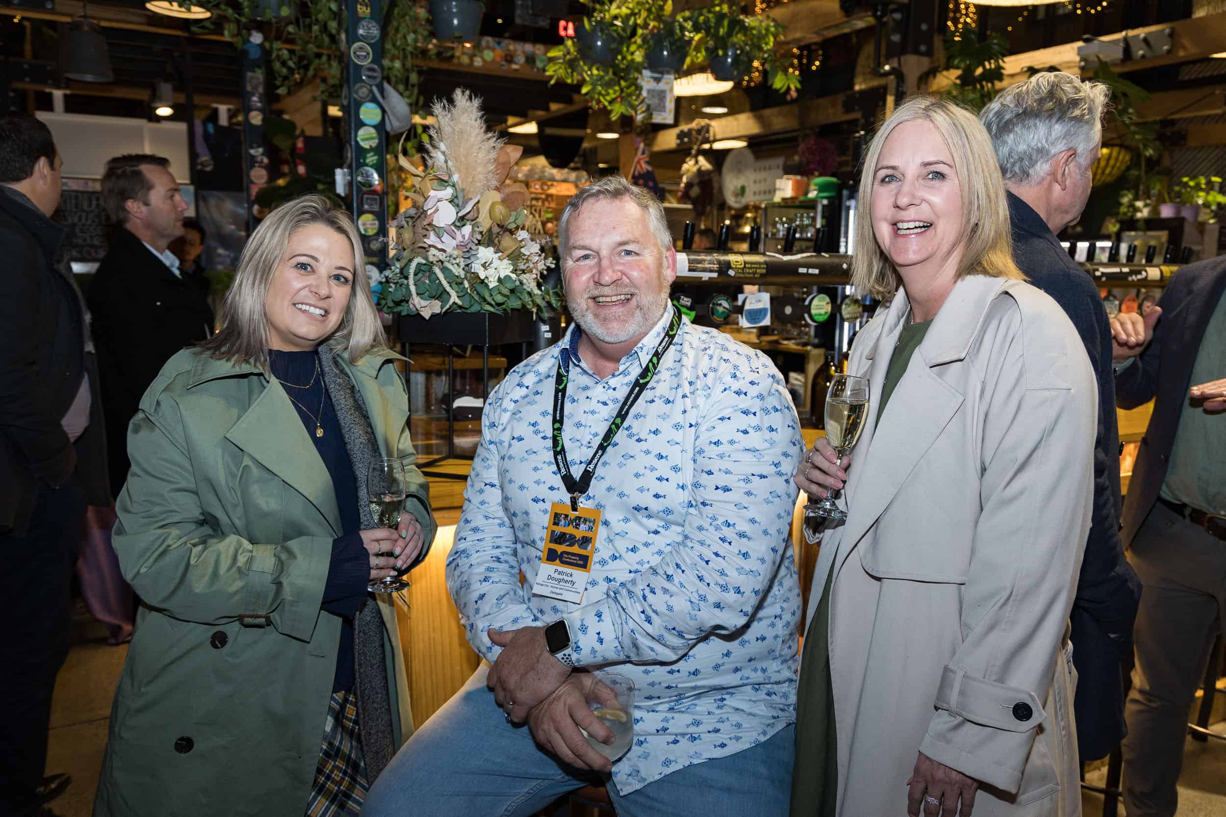 Casual group of three business people at a corporate drinks function, Christchurch.