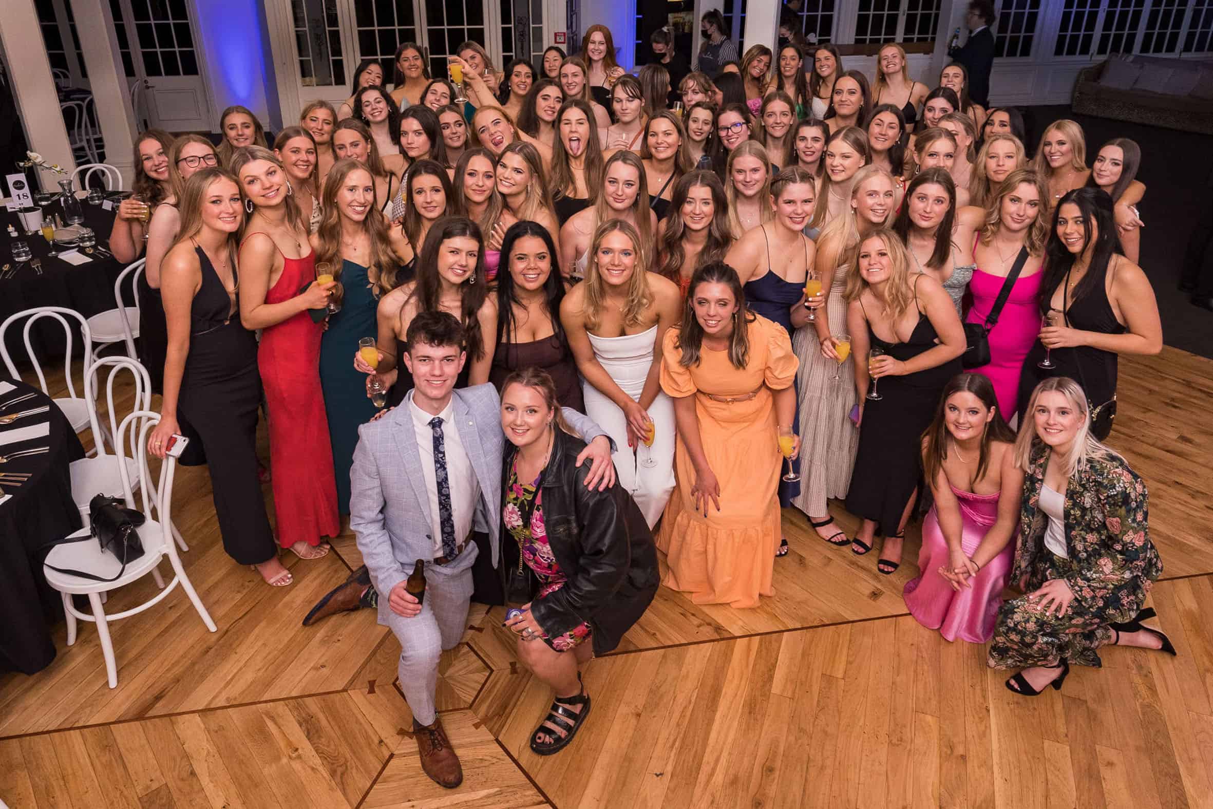 A large group of girls pose with one lone male on the dance floor at Pemberton Function Centre.