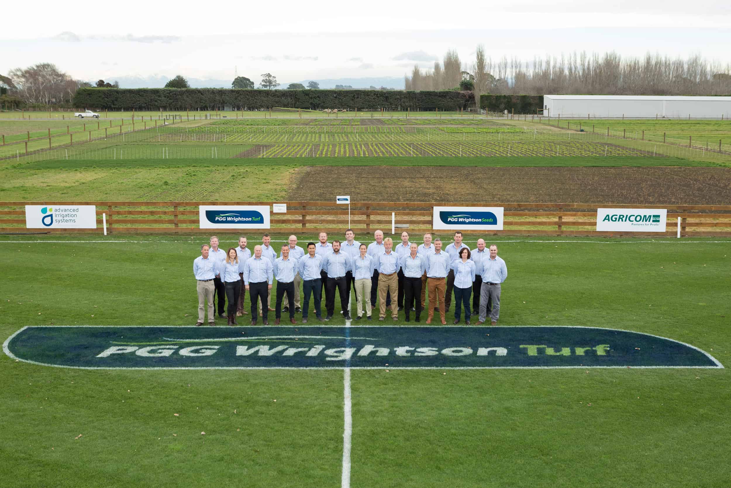 PGG Wrightsons staff pose on field at the Kimihia research facility.
