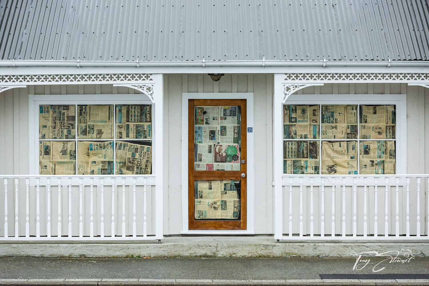 House with newpaper curtains.