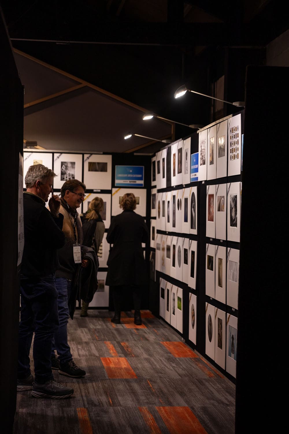 People looking at award prints at the 2023 NZIPP Sony Iris Awards Christchurch