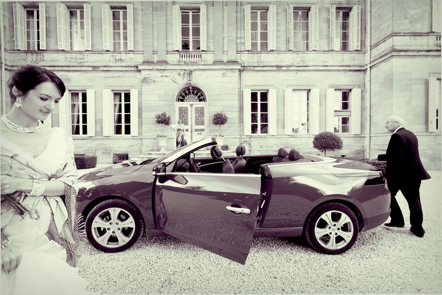 Bride and father arrive at a wedding in sports car.