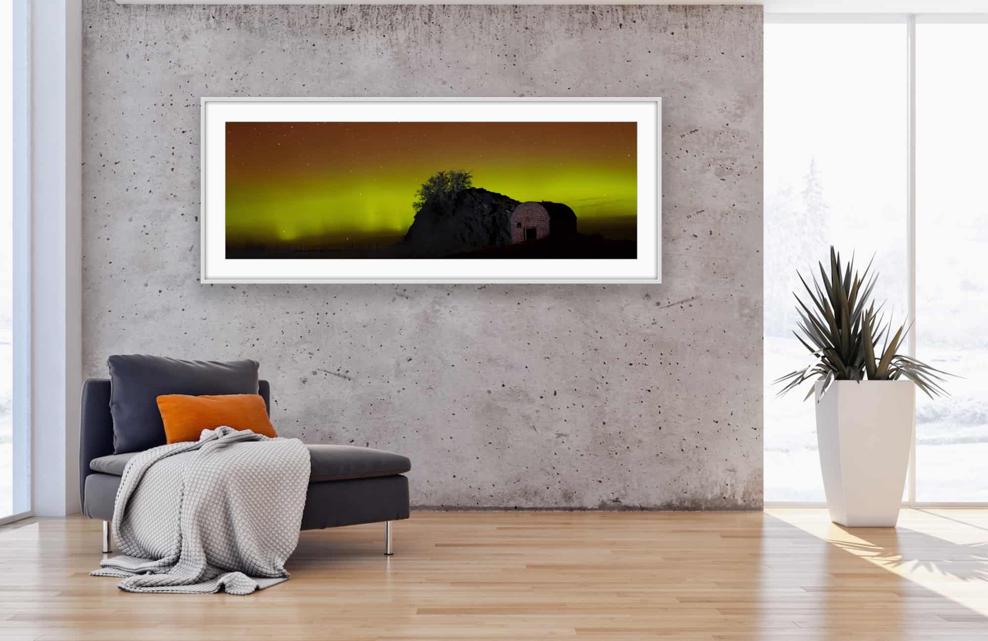 Framed print of the Aurora Australis displayed on a living room wall, taken by Christchurch photographer Tony Stewart.
